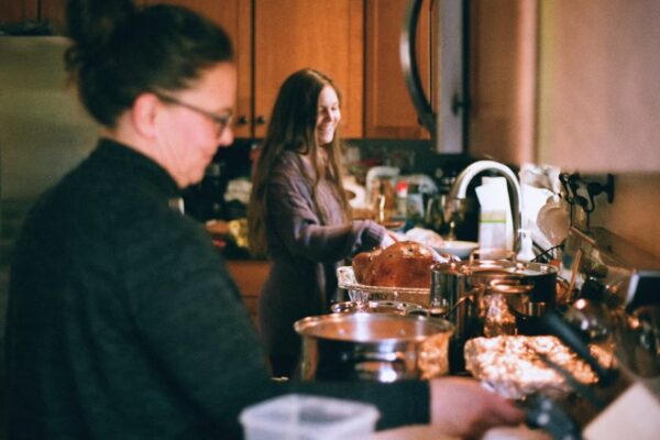 Two people talking warmly over coffee at home